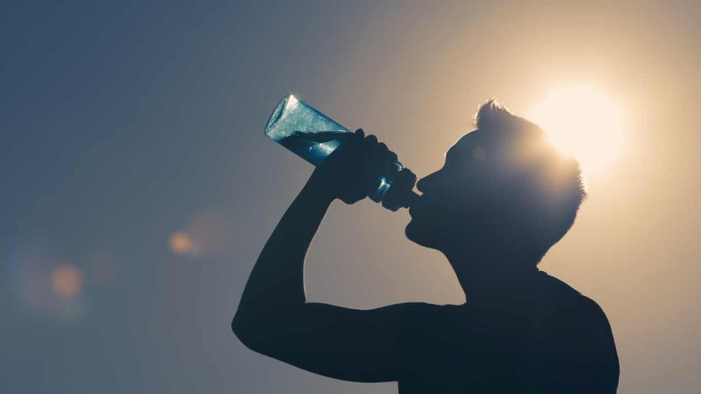 a men drinking water in summar day